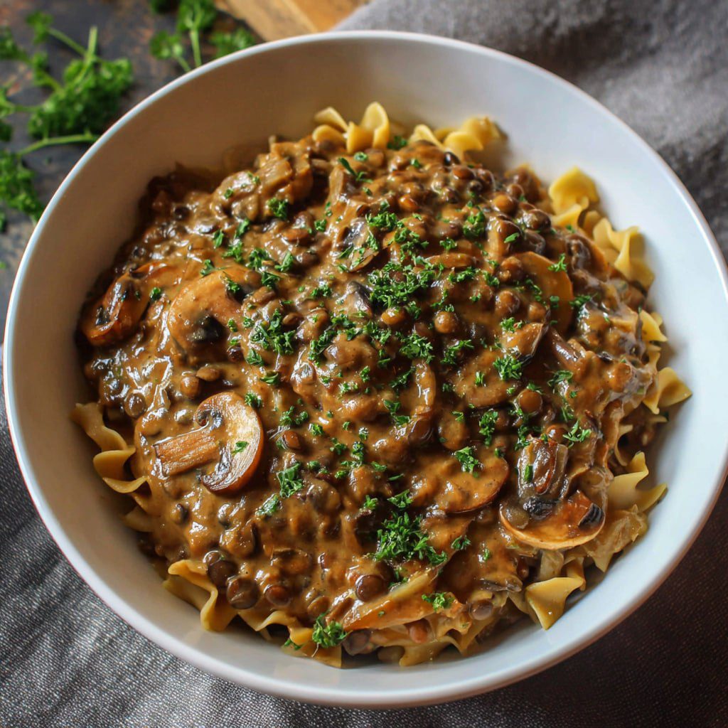 Easy vegan lentil mushroom stroganoff the whole family loves served over egg-free noodles with creamy sauce